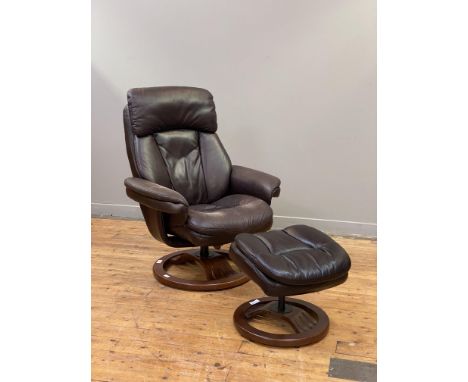 A Vintage faux leather upholstered reclining chair and footstool.&nbsp;