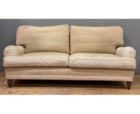 A traditional two seat sofa, the frame and squab cushions upholstered in yellow chenille, raised on turned front supports. H7