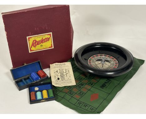 A 1950's Chad Valley Co LTD, Roulette kit comprising, a roulette, a boxed set blue and red poker chips, a boxed set of brown,