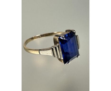 A 9ct yellow and white gold soliatire ring set blue synthetic sapphire with arched panel table to top N 1.92g
