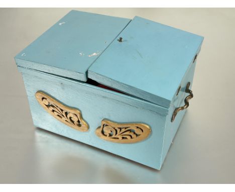 A vintage turquoise blue pained sewing box with grass carry handles to side with fitted interior containing thread, trims fab