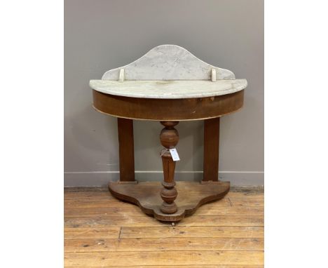 A Victorian mahogany bowfront Duchess console table, with raised back, open shelf, and top in white marble, above a plain fri