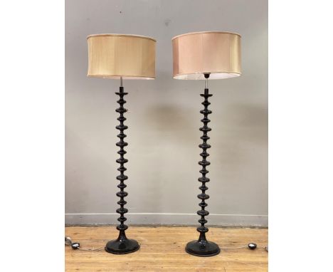 A pair of contemporary lamp standards of bobbin form, complete with cylindrical shades. H160cm.&nbsp;