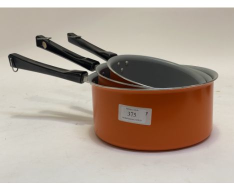 A set of three vintage TEFAL orange enamel saucepans, circa 1970 in unused condition.&nbsp;