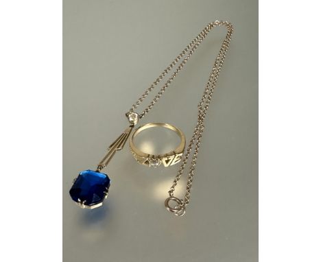 A 9ct gold mounted pendant on fitted chain set cushion cut blue stone on Art Deco style suspension set cz on trace link chain