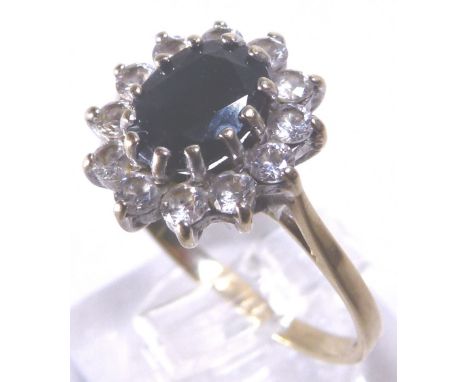 GOLD DIAMOND RING. 9 ct yellow gold diamond and dark ruby set ring