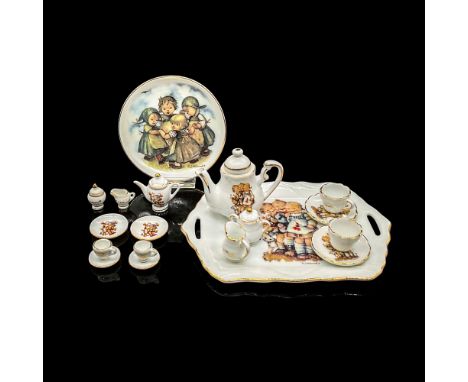 Porcelain miniature tea sets and small dish featuring pleasant images of children. Eight piece mini tea set with serving tray