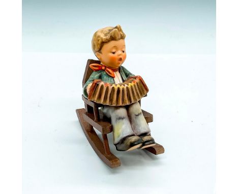 First Issue, hand painted boy playing an accordion sitting in a wood rocking chair. Goebel Germany backstamp. Impress mark 77
