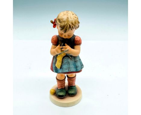 Hand painted girl with blue apron and knitting needles. Goebel Germany backstamp. Impress mark 255. Issued: 1991Dimensions: 6