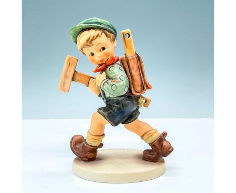 Hummel porcelain figure depicts a young boy carrying a stack of wooden boards and a backpack. The boy is wearing a hard hat a