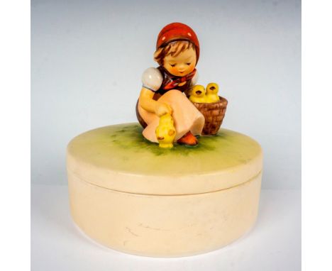 Hand painted in matte finish round box. The lid of the box features the figurine Chick Girl depicting a German farmer feeding