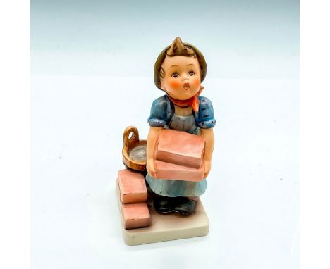 Hand painted child with green cap lifting bricks. Goebel German backstamp. Impress mark 305. Issued: 1999Dimensions: 2.5"L x 