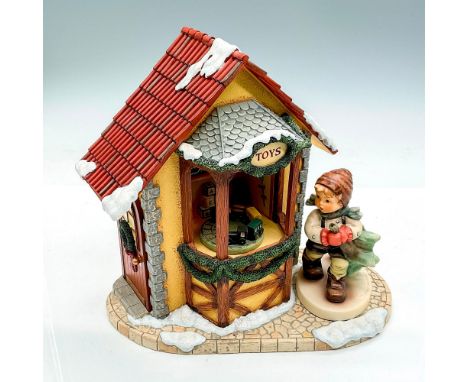 Hand painted boy in brown cap carrying a recently cut Christmas Tree. The base is Holiday Dreaming battery operated music box