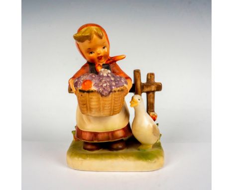 Hand painted in matte finish figurine in the style of Goebel-Hummel. This cute figure depicts a farm girl carrying basket ful