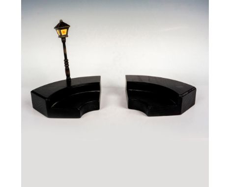 A black wooden display stand with a lamp post that can be split into two sections. This charming stage is for the Goebel Humm