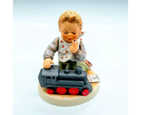 First Issue 2003, hand painted boy with toy locomotive. Goebel Germany backstamp. Impress mark 2157. Issued: 2003Dimensions: 