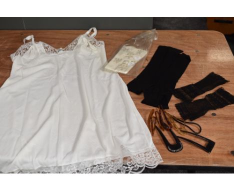 A selection of vintage and antique hair combs,fingerless mittens and a petticoat.