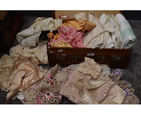 A vintage suitcase containing a large selection of table linen,crotchet work and more.