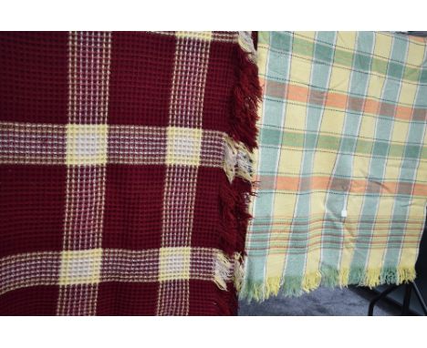 A lovely bright vintage waffle blanket in red and yellow and another blanket having check pattern.