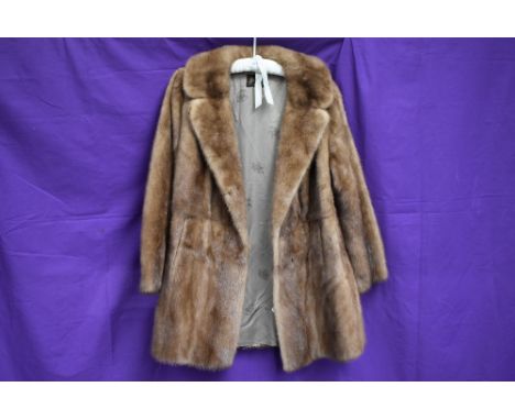A vintage mink coat having half belt to back, around a medium size.