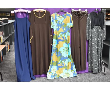 A mixture of vintage dresses,60s-70s, including bright patterned maxi dress.