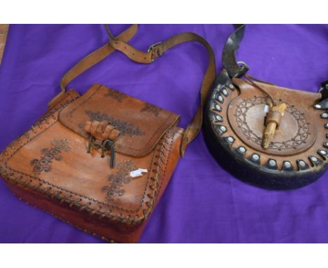Two vintage leather bags having stitched and embossed details.