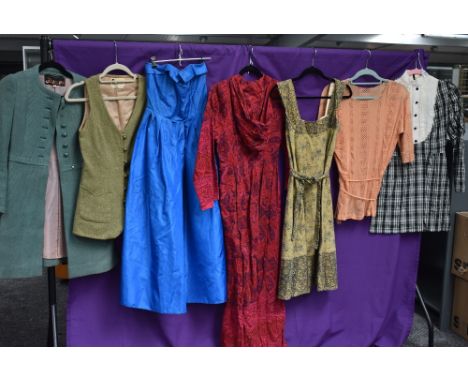 A mixed lot of ladies vintage clothing including maxi dress, waist coat and more.