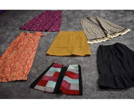 An assortment of colourful vintage skirts,predominantly 60s and 70s including wonderful patchwork suede mini skirt.
Due to ag