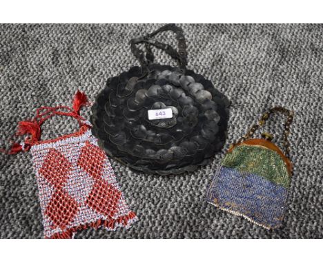 A trio of vintage and antique handbags including circular leather bag in black and two smaller beaded ones.