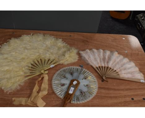 Three vintage and antique fans, two feathered and one paper with mirror to carved wood centre.