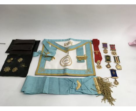 A Masonic apron and sash plus related various medallions