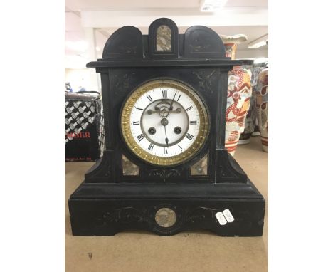 A Victorian slate mantel clock, the enamel dial presenting Roman numerals, approximately 36cm tall.
