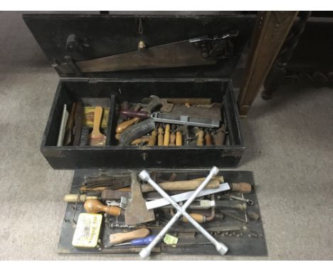 A wooden tool trunk containing various woodworking tools