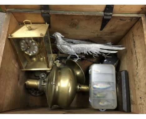 A pine trunk and contents including a carriage clock, fishing gear, oil lamp etc.