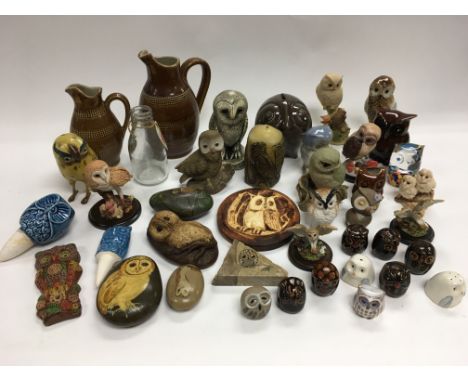A collection of mainly ceramic owl ornaments.