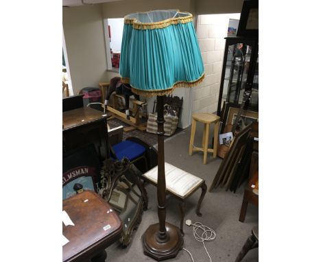 A standard lamp and a carved oak mirror.
