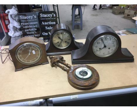 A wall barometerand three mantel clocks including one electric example.