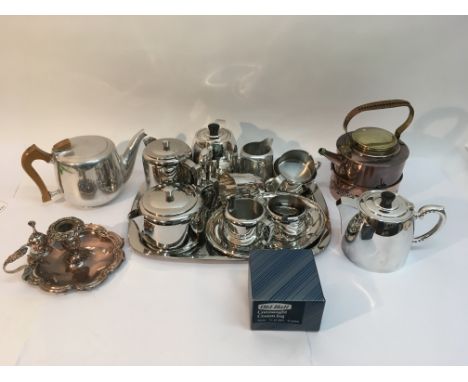 A silver plated candlestick, a copper spirit kettle and a collection of modern stainless steel