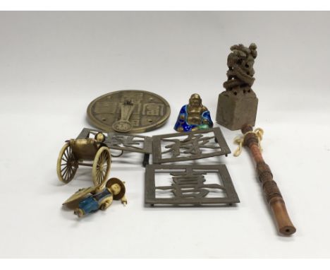A collection of Oriental items including a carved hard stone seal, a gilt metal and enamel Buddha figure and other items.