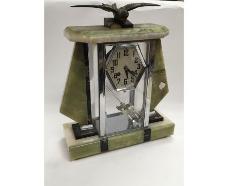 An Art Deco 8 day mantle clock surmounted with a metal bird figure, approx 38cm.