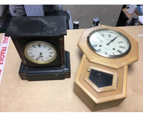 An Acctim wall clock together with a black slate mantel clock.