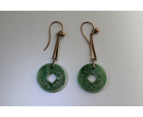 A pair of 1920/30 jade bi disk earrings, the drop earrings with unmarked yellow gold fittings.