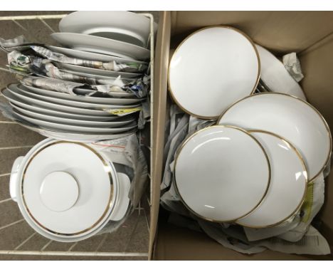 Two boxes containing a Thomas German dinner and tea service in white with giltwork decoration.