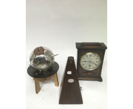 A metronome, mantle clock and German barometer