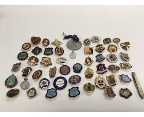 A collection of enamel badges, mostly bowling clubs.