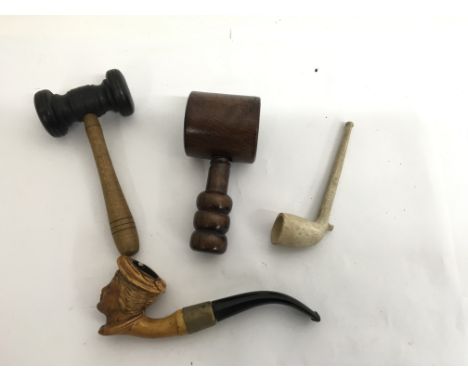 Two wooden gavels, carved wood pipe with figurative bowl and a clay example