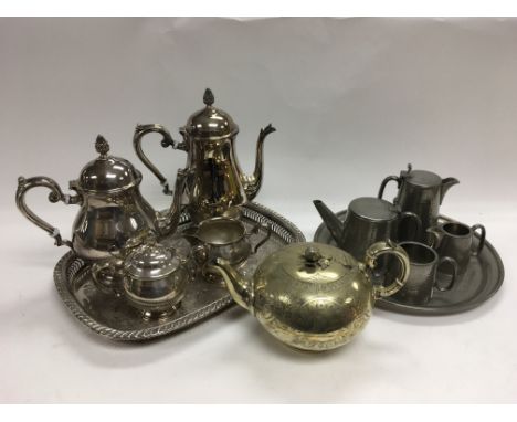 A silver plated tea set and tray, an English pewter tea service plus one other teapot.