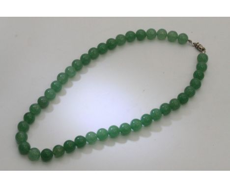 A jade choker necklace with white metal clasp.