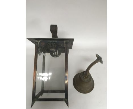 An Art Nouveau copper and glass lantern with bracket and a bell, lacking ringer