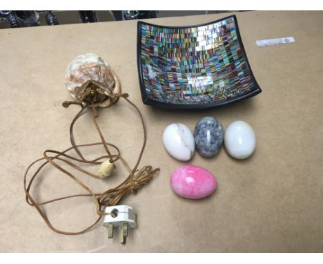 A carved cameo shell lamp together with a glass mosaic dish and 4 marble eggs.